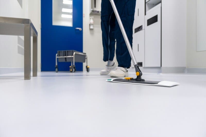Janitorial crew cleaning office lobby at night